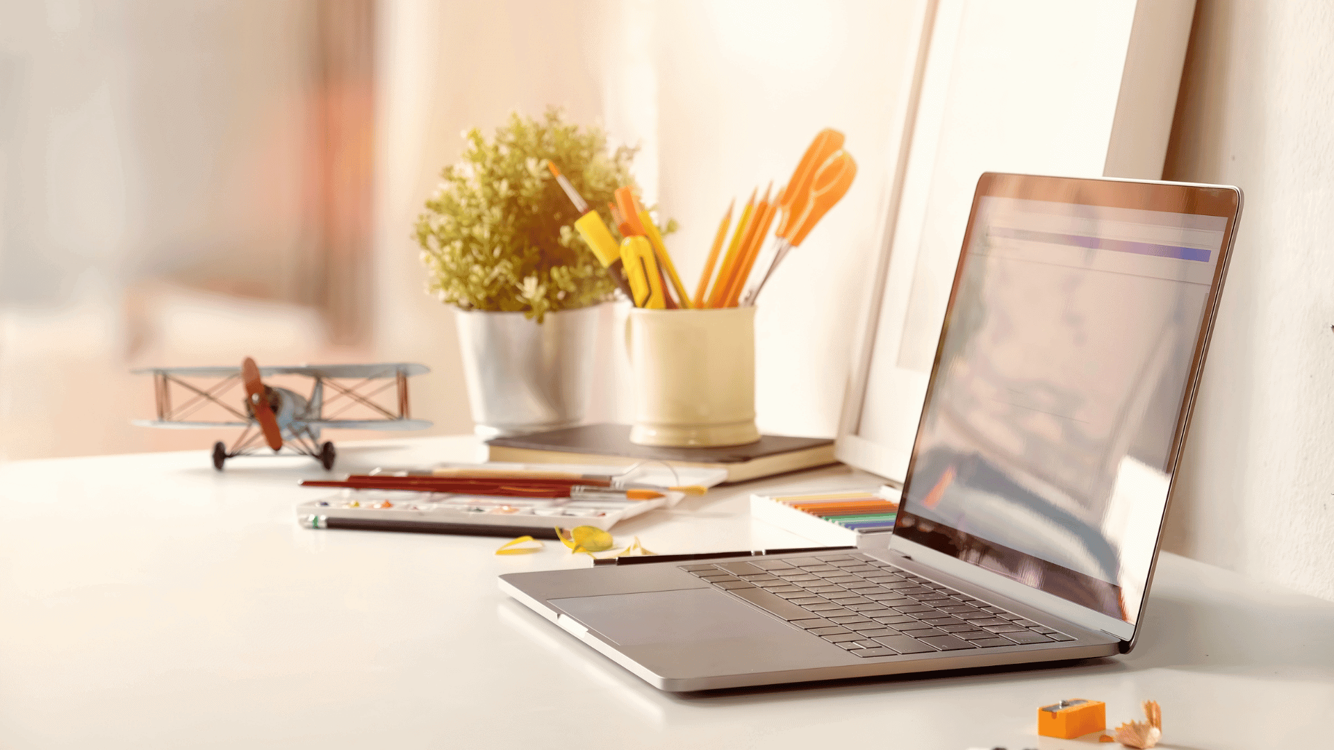 Clean desk with laptop and office supplies, representing employment process and HR solutions.